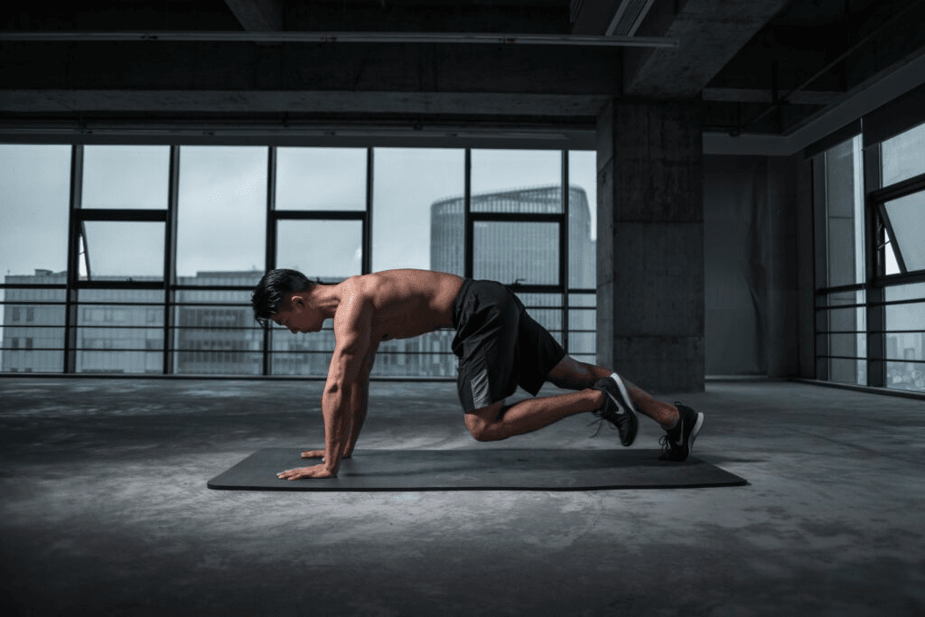 A man doing mountain climbers in an industrial looking gym