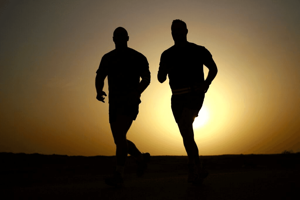 Two men running in the light of dusk